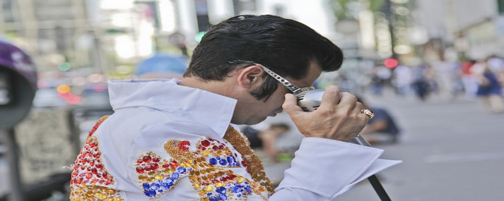 SAO PAULO BRAZIL - FEBRUARY 08 2015: An unidentified street musician imitates Elvis Presley dressed with typical vintage rock dress in Paulista Avenue at Sao Paulo Brazil.